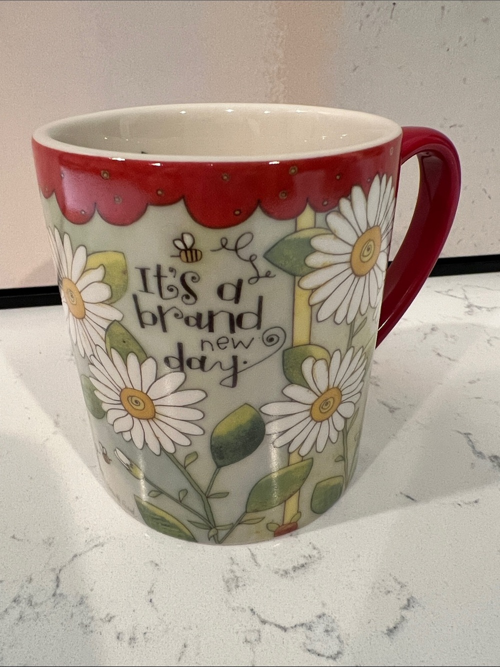 Lang’s “Brand New Day" microwave and dishwasher safe ceramic coffee mug